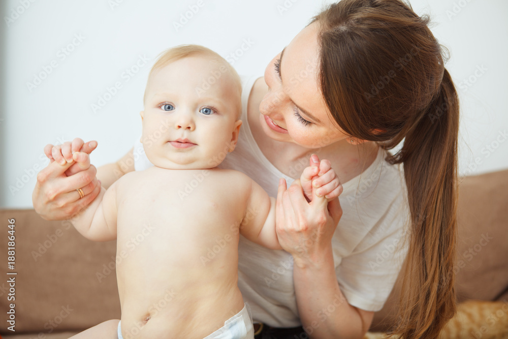 Mother takes care about her adorable infant toddler, happy motherhood Mother takes care about her adorable infant toddler, happy motherhood