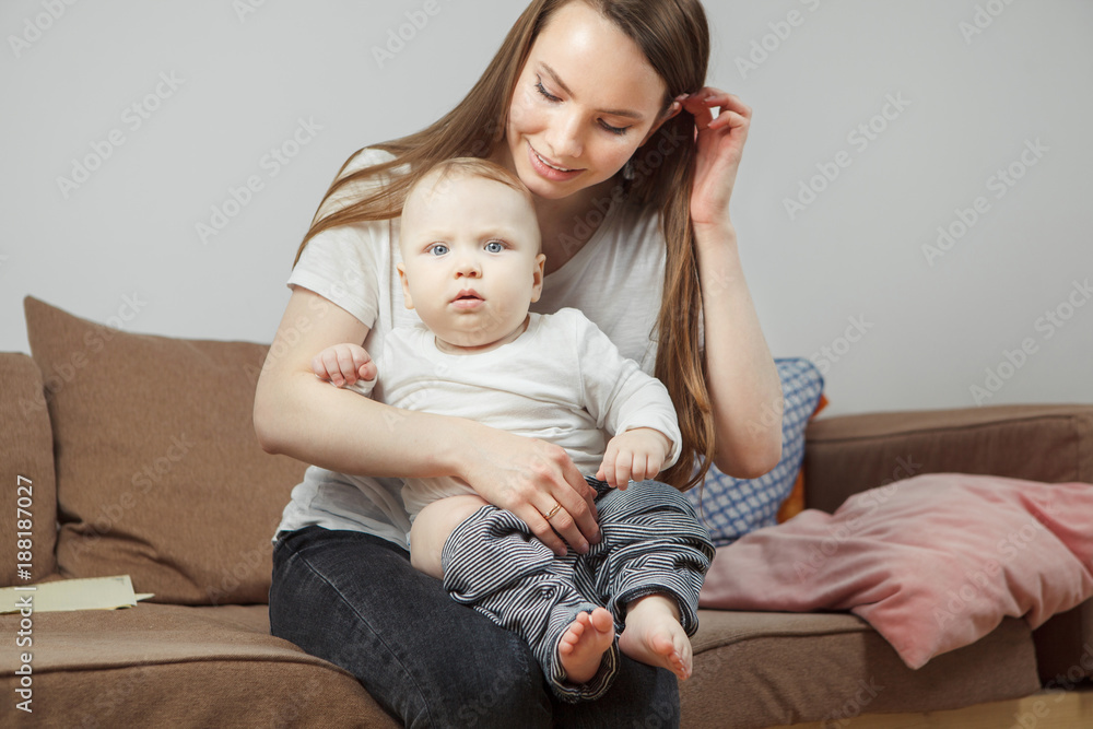 Mother holds on hands her favourite child going to change him clothes. Mother holds on hands her favourite child going to change him clothes.