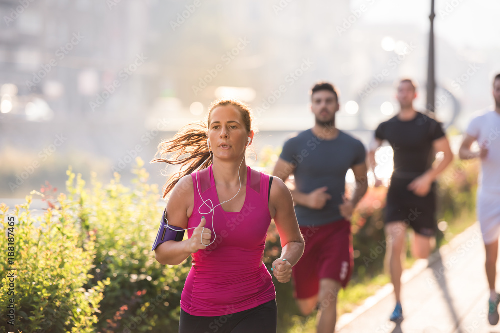 Fototapeta premium group of young people jogging in the city