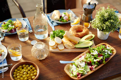 Healthy homemade food served for guests on wooden table outdoors