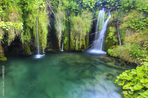 Fototapeta Naklejka Na Ścianę i Meble -  Close up of blue waterfalls in a green forest during daytime in Summer.Plitvice lakes, Croatia