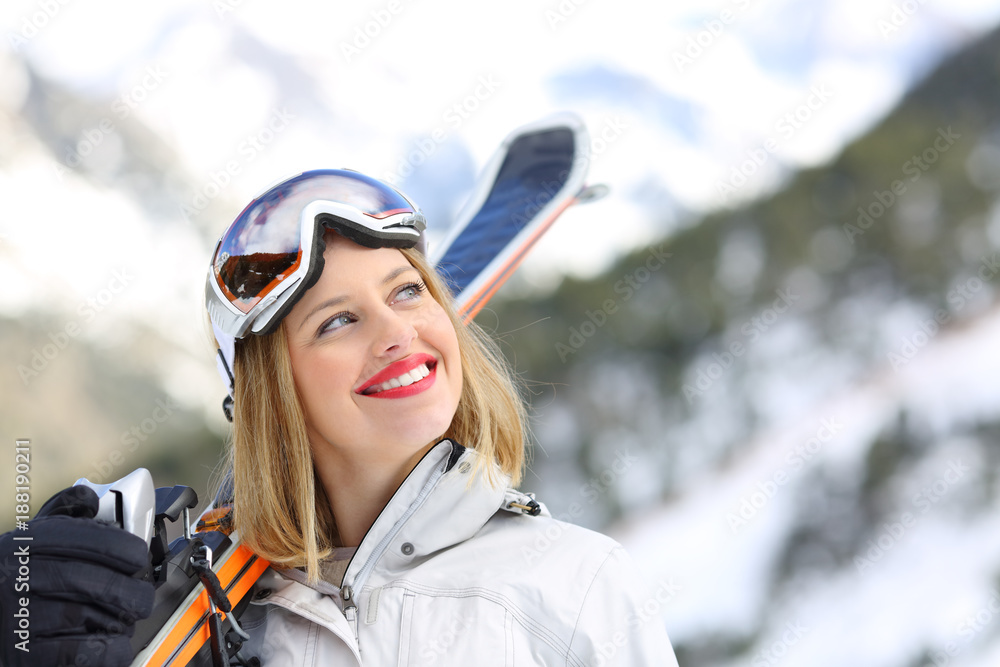 Satisfied skier looking at side in the mountain Satisfied skier looking at side in the mountain
