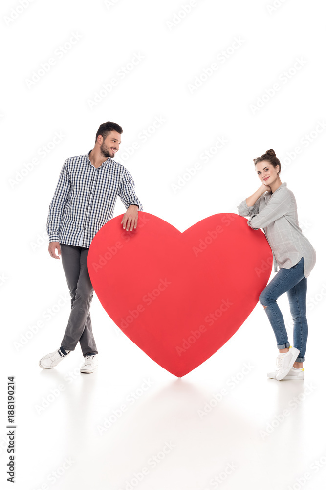 couple leaning on big heart on white, valentines day concept couple leaning on big heart on white, valentines day concept