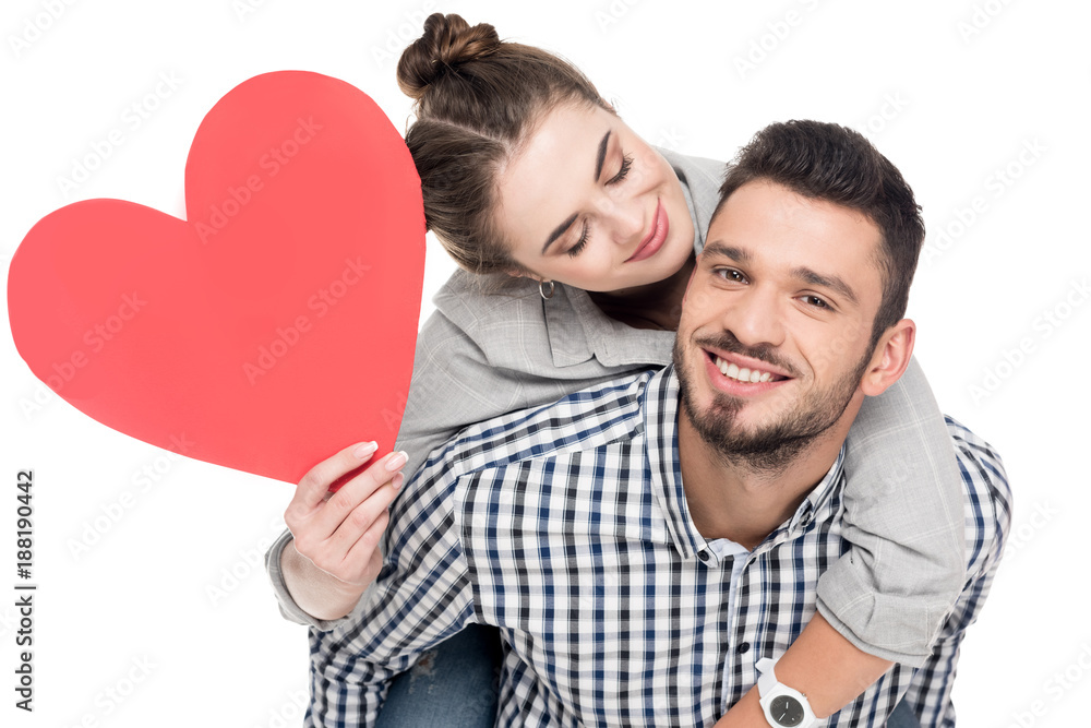 boyfriend giving piggyback to girlfriend holding red heart isolated on white, valentines day concept