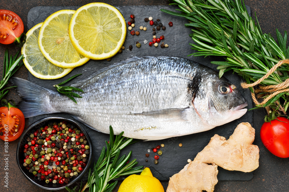 Food background. Fresh, raw Dorado with a swallow, lemon, avocado on a dark concrete background. Food background. Fresh, raw Dorado with a swallow, lemon, avocado on a dark concrete background.