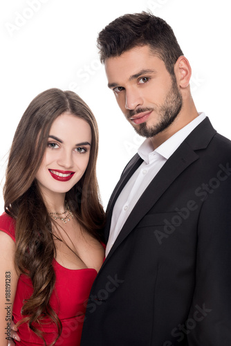 smiling attractive heterosexual couple in evening outfit isolated on white