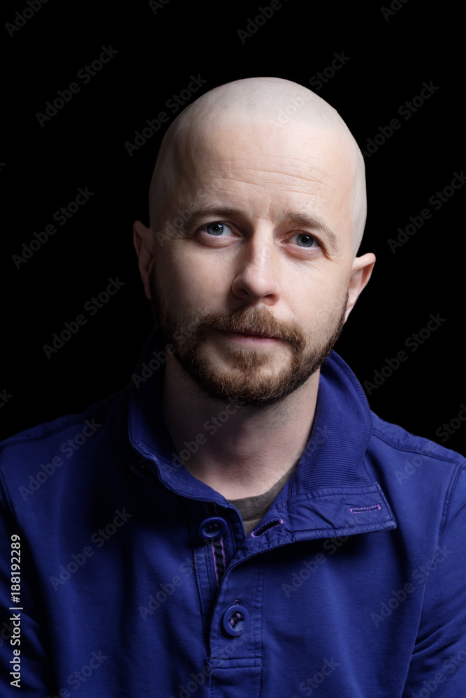Bald bearded caucasian man in his 30s isolated on black background. 24mp file shot in a studio setting. Bald bearded caucasian man in his 30s isolated on black background. 24mp file shot in a studio setting.