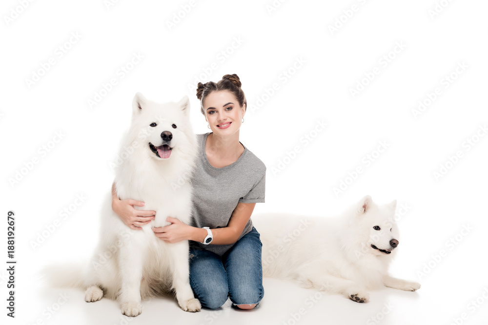 smiling girl sitting with dogs on white