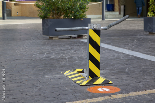 picture of a broken parking limiter. Black and yellow parking limiter.