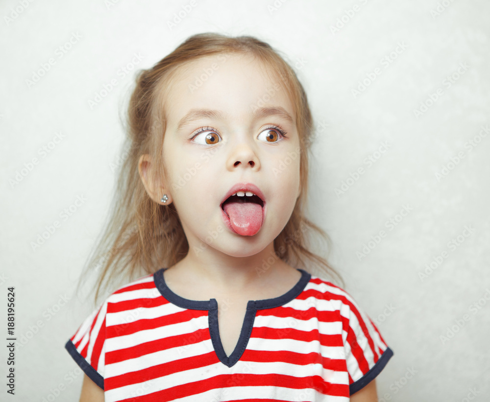 Adorablr little girl pulls her tongue out and looks sideways Adorablr little girl pulls her tongue out and looks sideways