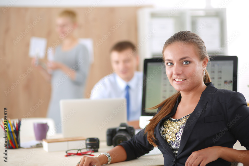 Portrait of an attractive young businesswoman sitting in front of a computer.businesswoman . Portrait of an attractive young businesswoman sitting in front of a computer.businesswoman .