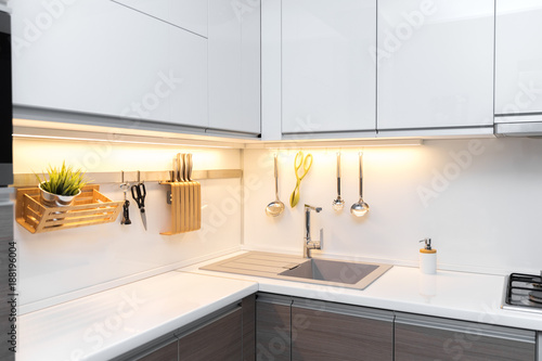 white gloss kitchen interior with worktop lighting