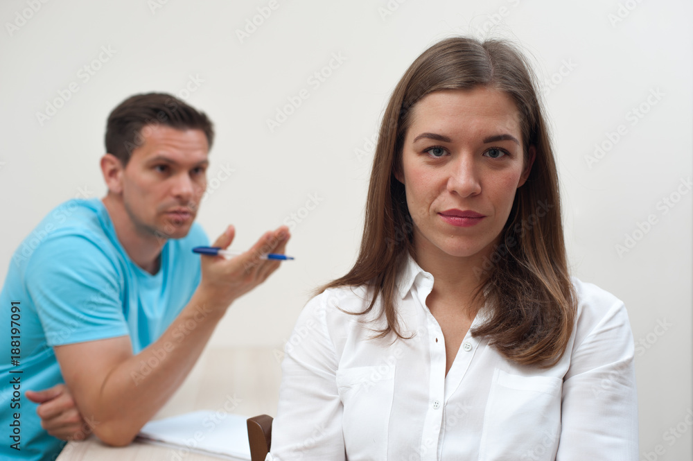 Sad blurred man in casual clothes begs forgiveness for pretty woman on white background Sad blurred man in casual clothes begs forgiveness for pretty woman on white background