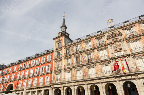 Detail of a decorated facade with traditional windows and balconies at the Palza Mayor, Madrid, Spain.