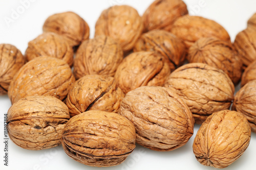 Closed walnuts on white table