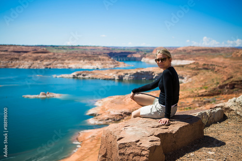 Beautiful young tourist woman watching lake Powell amazing panorama. Famous touristic places in USA. American city travel concept.