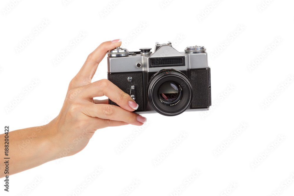 Hand holds an old photo camera, isolated Hand holds an old photo camera, isolated