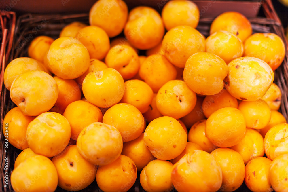 Yellow organic plums in the market.  Whole fresh plums harvest.  Food background