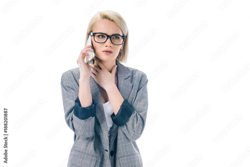 attractive worried businesswoman talking on smartphone, isolated on white