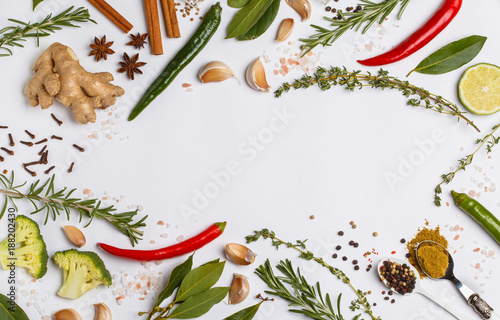 Selection of spices, herbs and greens. Ingredients for cooking. White background, top view, copy space.