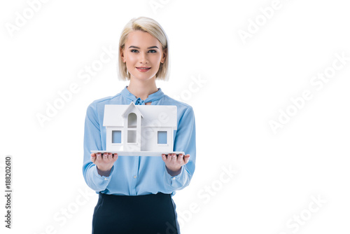 beautiful elegant agent presenting house model, isolated on white