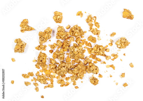 Crunchy granola, muesli pile with peanuts isolated on white background, top view