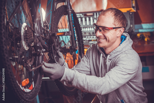 bike mechanic repairs bicycle in workshop