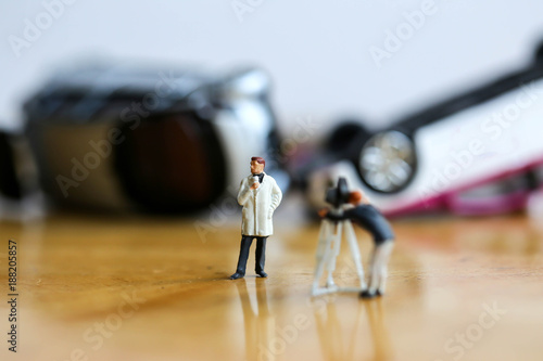 Miniature people : the small team of tv reporter with Car accident ,production television and accident concept. photo