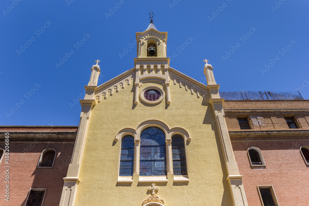 Yellow facade of a church at the plaza Vicent Iborra in Valencia