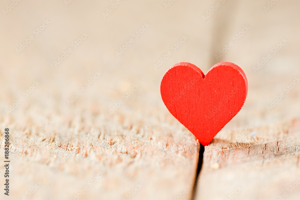 Fototapeta premium Heart on a wooden background. Background in the style of Valentine's Day. Heart on a wooden background