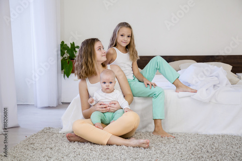 three sisters play children in the morning in the bedroom photo