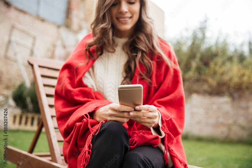Cropped image of a smiling woman texting Cropped image of a smiling woman texting