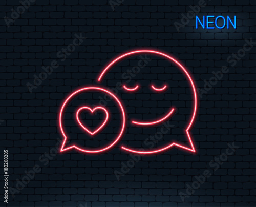 Neon light. Comic speech bubble with Smile line icon. Chat emotion with heart sign. Glowing graphic design. Brick wall. Vector