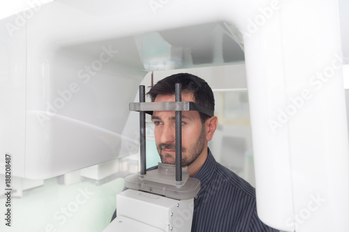 A handsome man having panoramic digital x-ray of his teeth. photo