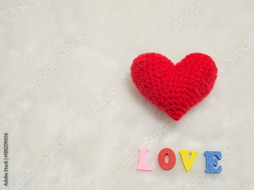 red yarn heart on white wool and alphabet I LOVE U. the red heart on the right of picture and background copy space for text. Valentines day  love concept and love background
