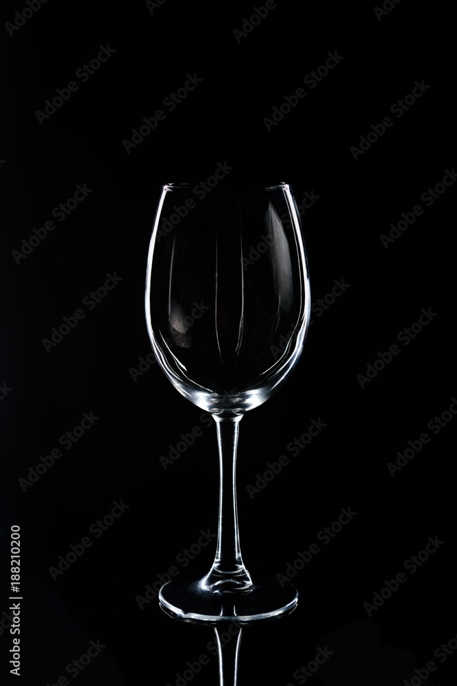 one wineglass on black reflecting tabletop one wineglass on black reflecting tabletop