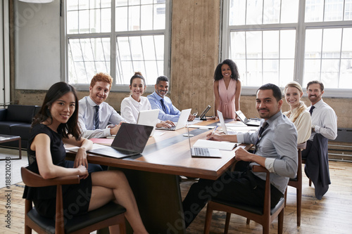 Black businesswoman and team at board meeting look to camera