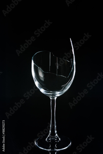 broken wineglass on black reflecting table