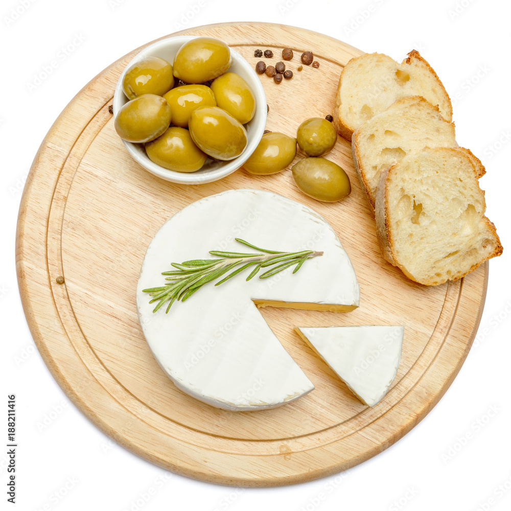 Round brie or camambert cheese on cutting board white background Round brie or camambert cheese on cutting board white background