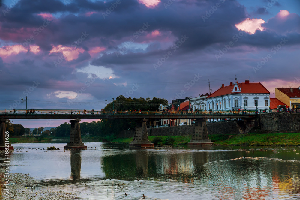 Fototapeta premium Evening pedestrian bridge in the center of Uzhgorod in the sunset Ukraine