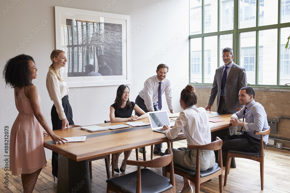 Young professionals around a table at a business meeting Young professionals around a table at a business meeting
