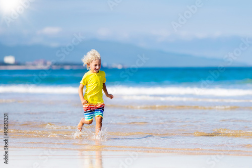 Child on tropical beach. Sea vacation with kids. © famveldman