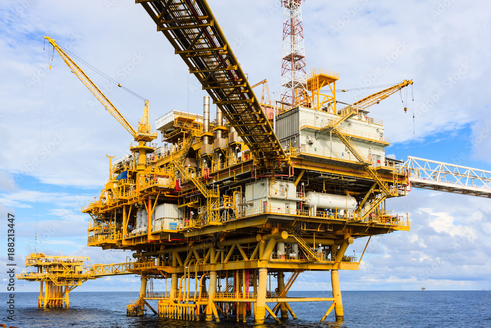 Offshore oil and Gas central processing platform and remote platform produced oil, natural gas and liquid condensate for set to onshore refinery from offshore in ocean sea background. Offshore oil and Gas central processing platform and remote platform produced oil, natural gas and liquid condensate for set to onshore refinery from offshore in ocean sea background.