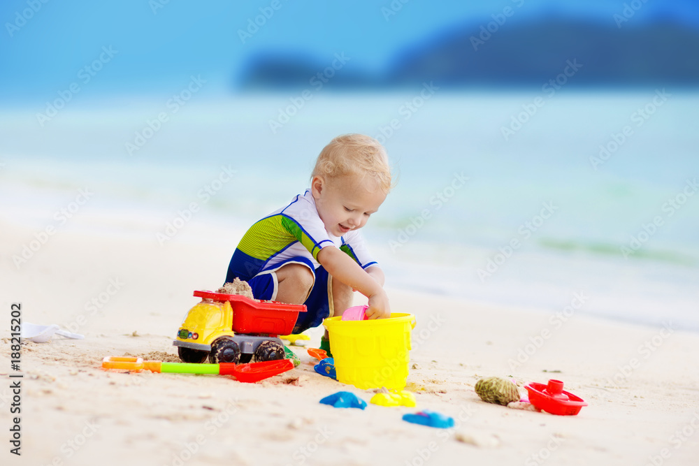 Kids play on tropical beach. Sand and water toy. Kids play on tropical beach. Sand and water toy.