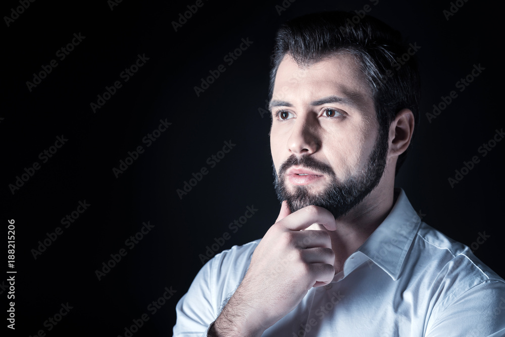 Full of thoughts. Portrait of a nice handsome thoughtful man holing his chin while thinking Full of thoughts. Portrait of a nice handsome thoughtful man holing his chin while thinking