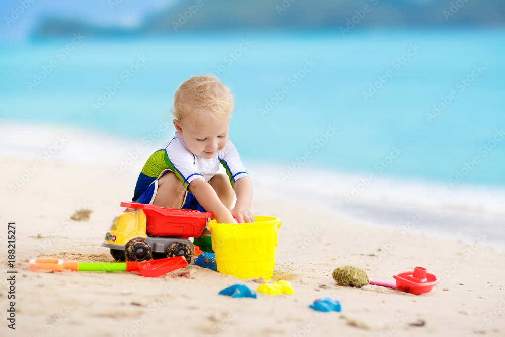 Kids play on tropical beach. Sand and water toy. Kids play on tropical beach. Sand and water toy.