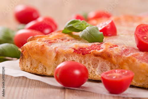 Italian pizza with cheese, tomatoes and fresh basil. 