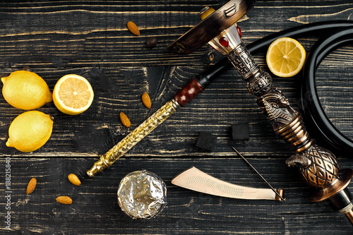 Dismantled parts of hookah on a wooden background with lemon fru