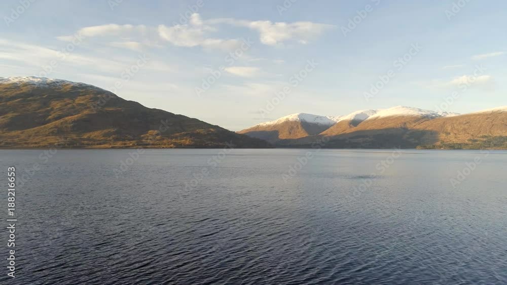 Scottish Loch at Sunset with Mountainous Landscape Scottish Loch at Sunset with Mountainous Landscape