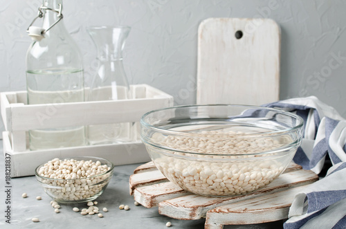 Photography White beans soaked in water in a glass bowl